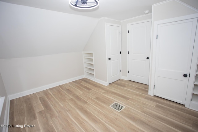 bonus room featuring vaulted ceiling and light hardwood / wood-style floors