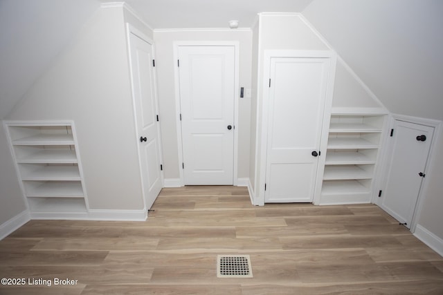 additional living space featuring light hardwood / wood-style flooring