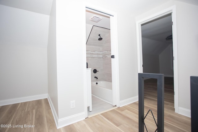 hallway with light hardwood / wood-style floors