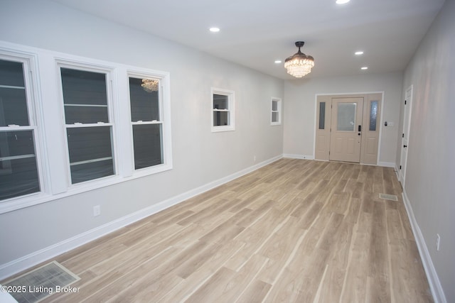 entrance foyer featuring a chandelier and light hardwood / wood-style flooring