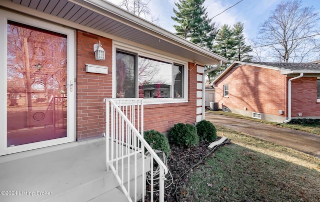 property entrance featuring central AC unit