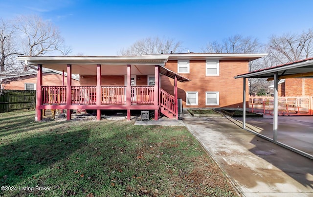 back of house with a yard and a patio