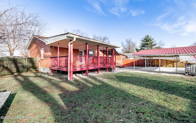 rear view of property with a lawn, a deck, and a patio