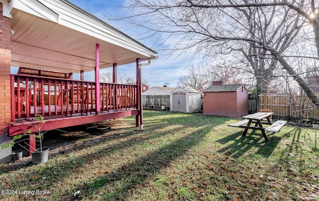 view of yard featuring a shed and a wooden deck