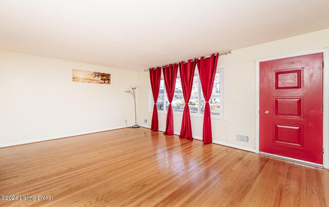 empty room with hardwood / wood-style flooring