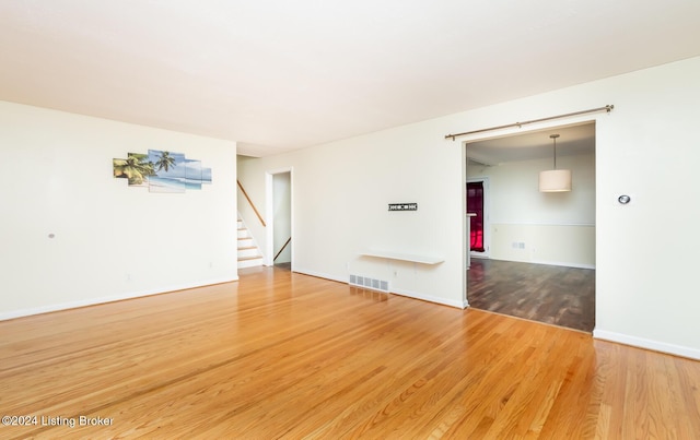 spare room with wood-type flooring