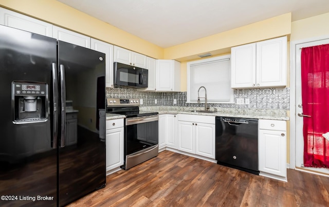 kitchen with black appliances, white cabinets, sink, dark hardwood / wood-style floors, and tasteful backsplash