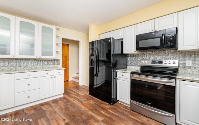 kitchen featuring white cabinets, light stone countertops, and black appliances