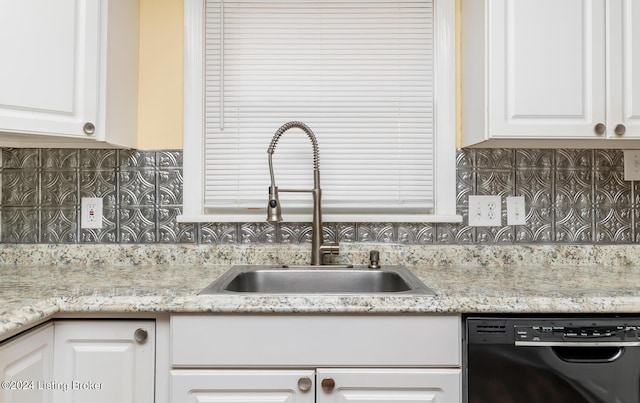 kitchen featuring white cabinetry, dishwasher, light stone countertops, sink, and backsplash