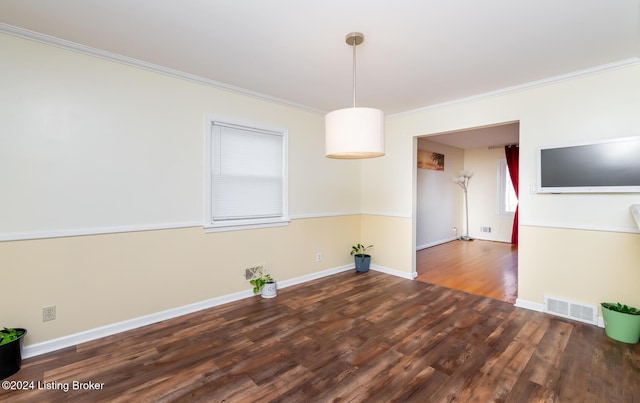 unfurnished dining area with ornamental molding and dark wood-type flooring