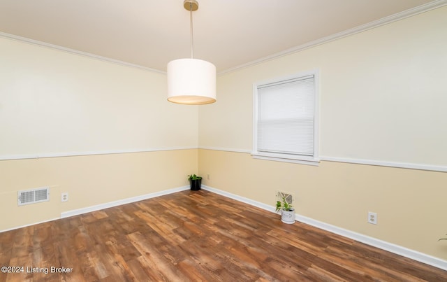 unfurnished room featuring dark wood-type flooring and ornamental molding