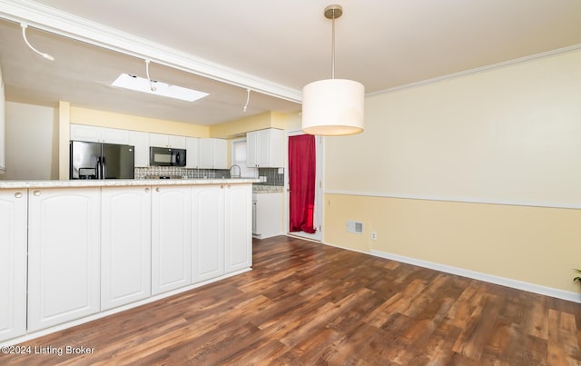 kitchen with white cabinetry, tasteful backsplash, dark hardwood / wood-style floors, stainless steel refrigerator with ice dispenser, and pendant lighting