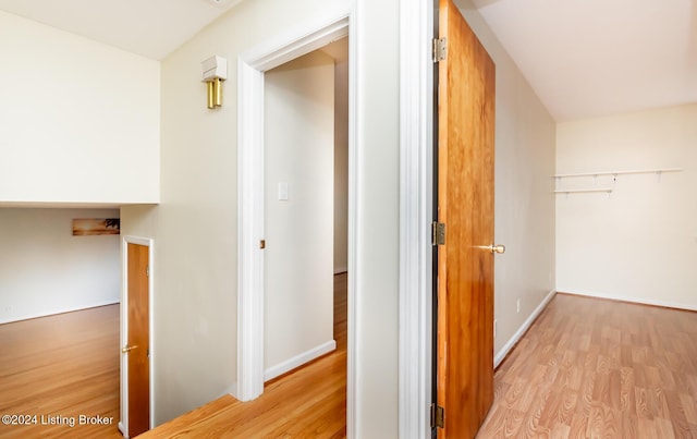 corridor with light hardwood / wood-style floors