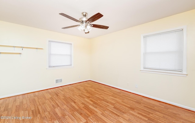 spare room with light wood-type flooring and ceiling fan