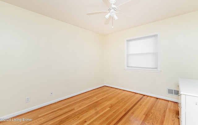 empty room featuring light wood-type flooring and ceiling fan