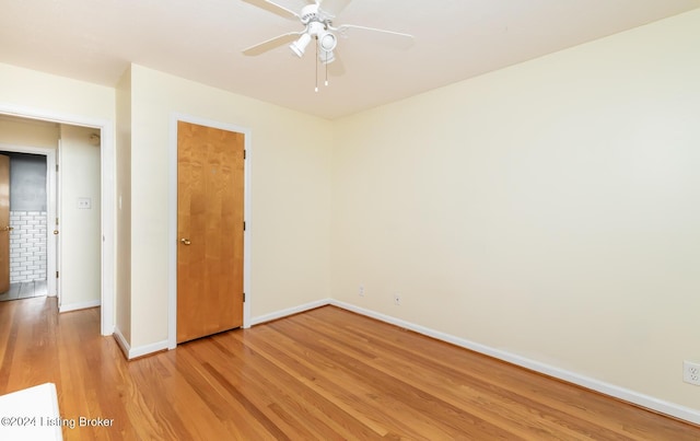 empty room featuring ceiling fan and light hardwood / wood-style flooring