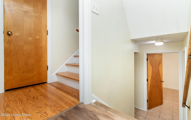 stairs with hardwood / wood-style flooring