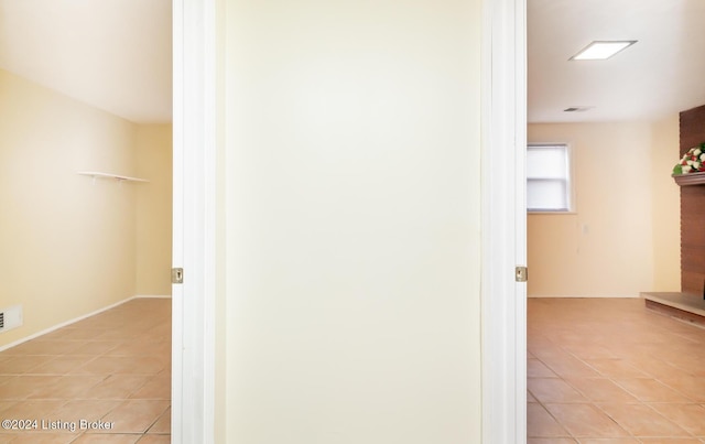 hallway featuring light tile patterned flooring