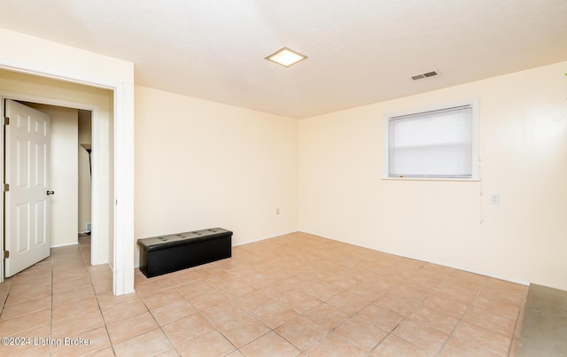 spare room featuring light tile patterned floors