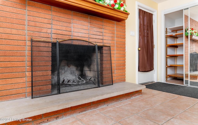 interior details with a brick fireplace