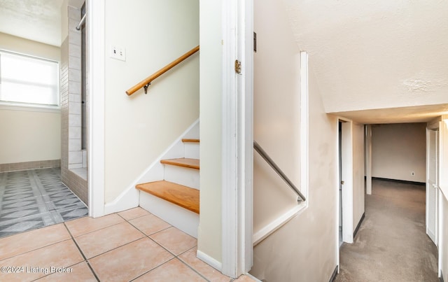 stairs with tile patterned flooring