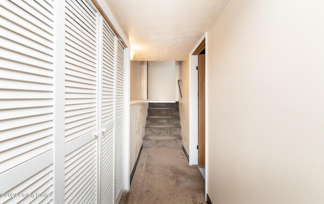 hallway featuring dark carpet