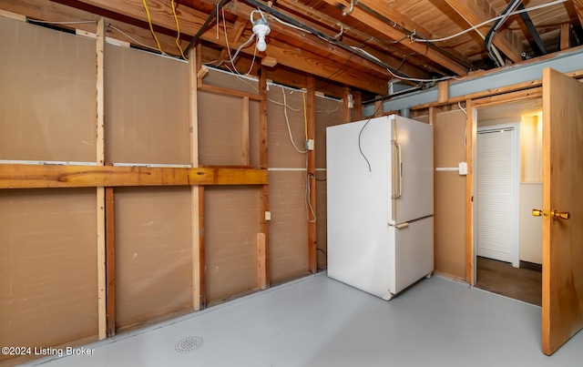 basement with white fridge