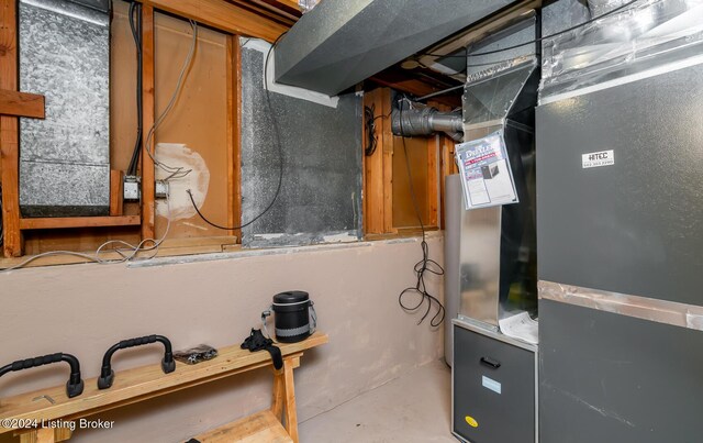 utility room featuring heating unit