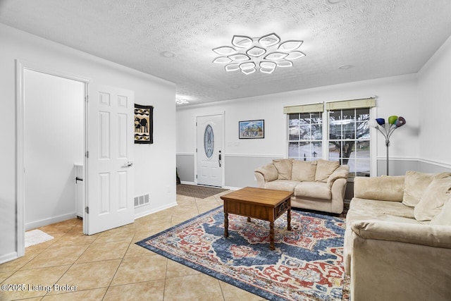 living room featuring light tile patterned floors and a textured ceiling