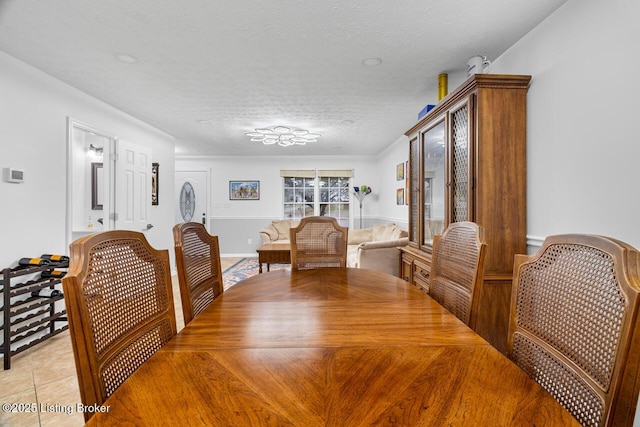 tiled dining area with a textured ceiling