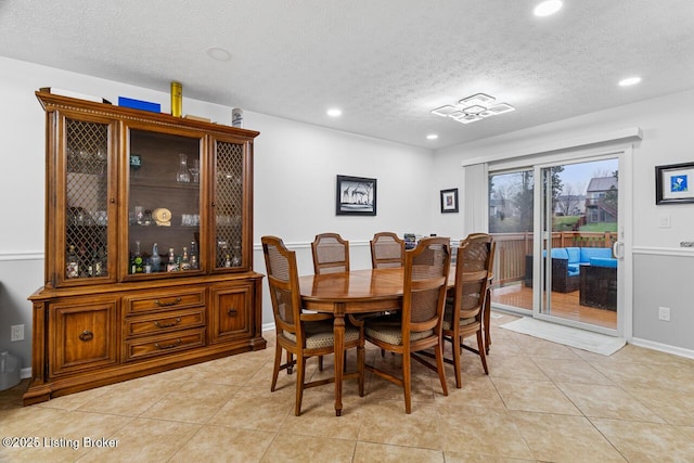 tiled dining room with a textured ceiling