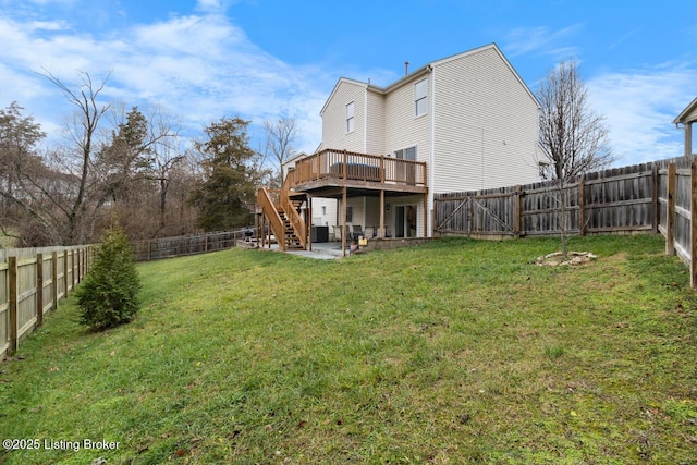 rear view of property featuring a lawn and a wooden deck