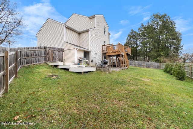 rear view of property with a lawn and a wooden deck