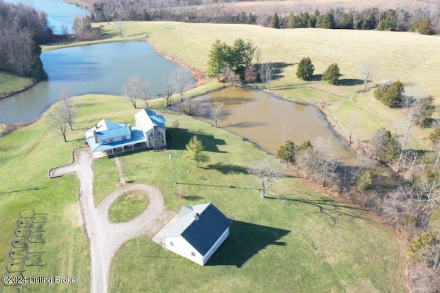 birds eye view of property with a water view and a rural view