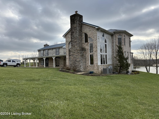 view of property exterior featuring central AC and a yard