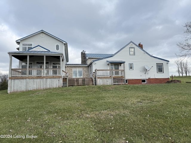 rear view of property featuring a yard