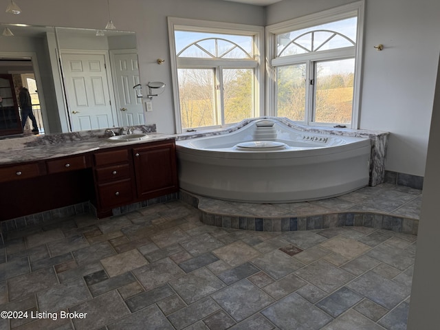 bathroom with a bathing tub and vanity