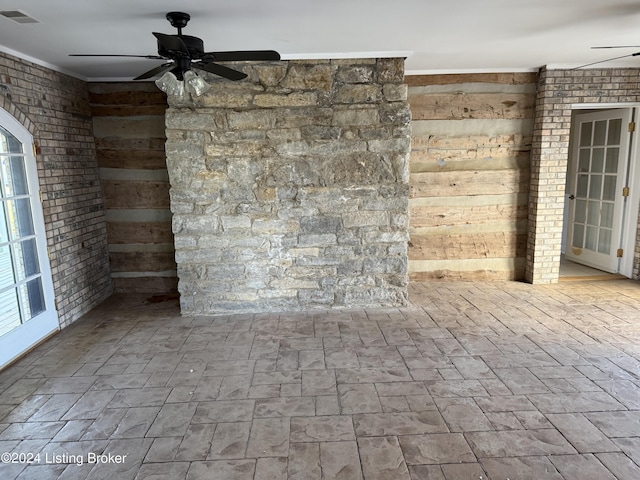 unfurnished living room with ornamental molding