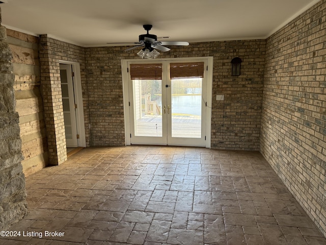 unfurnished room with french doors, ceiling fan, and crown molding