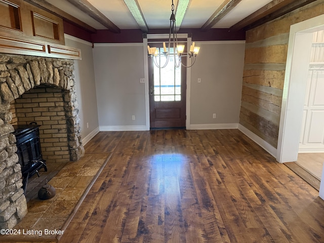 entrance foyer with beamed ceiling, dark hardwood / wood-style flooring, and an inviting chandelier