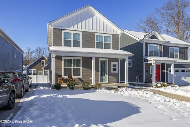 front of property featuring covered porch and a garage