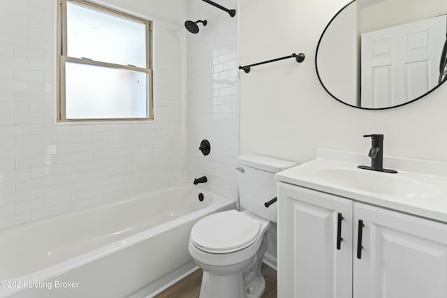 full bathroom featuring toilet, vanity, hardwood / wood-style flooring, and tiled shower / bath combo