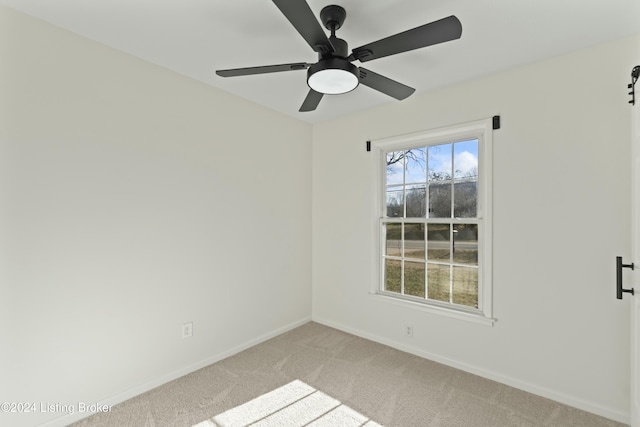 carpeted empty room featuring ceiling fan