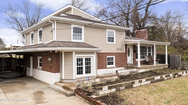 view of front of home featuring a carport and covered porch