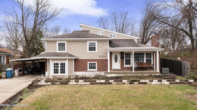 view of front of house with cooling unit, covered porch, and a front yard