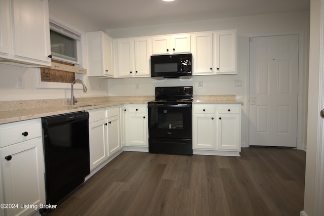 kitchen with white cabinetry, sink, light stone counters, dark hardwood / wood-style floors, and black appliances