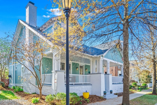 view of side of property with a porch