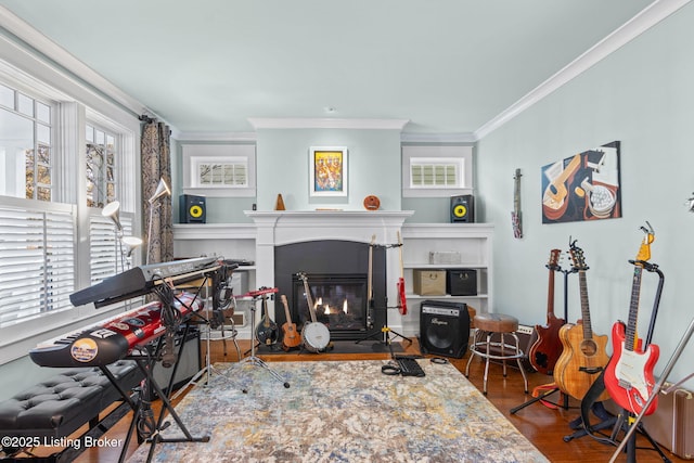 living room with hardwood / wood-style flooring and crown molding