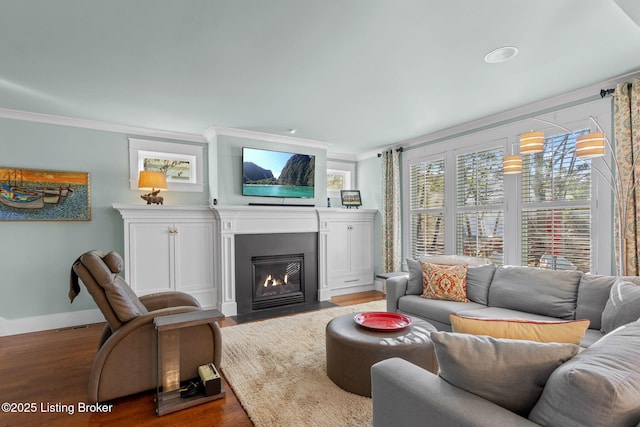 living room with hardwood / wood-style floors and ornamental molding