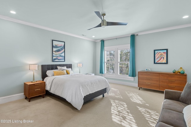 carpeted bedroom featuring ceiling fan and ornamental molding